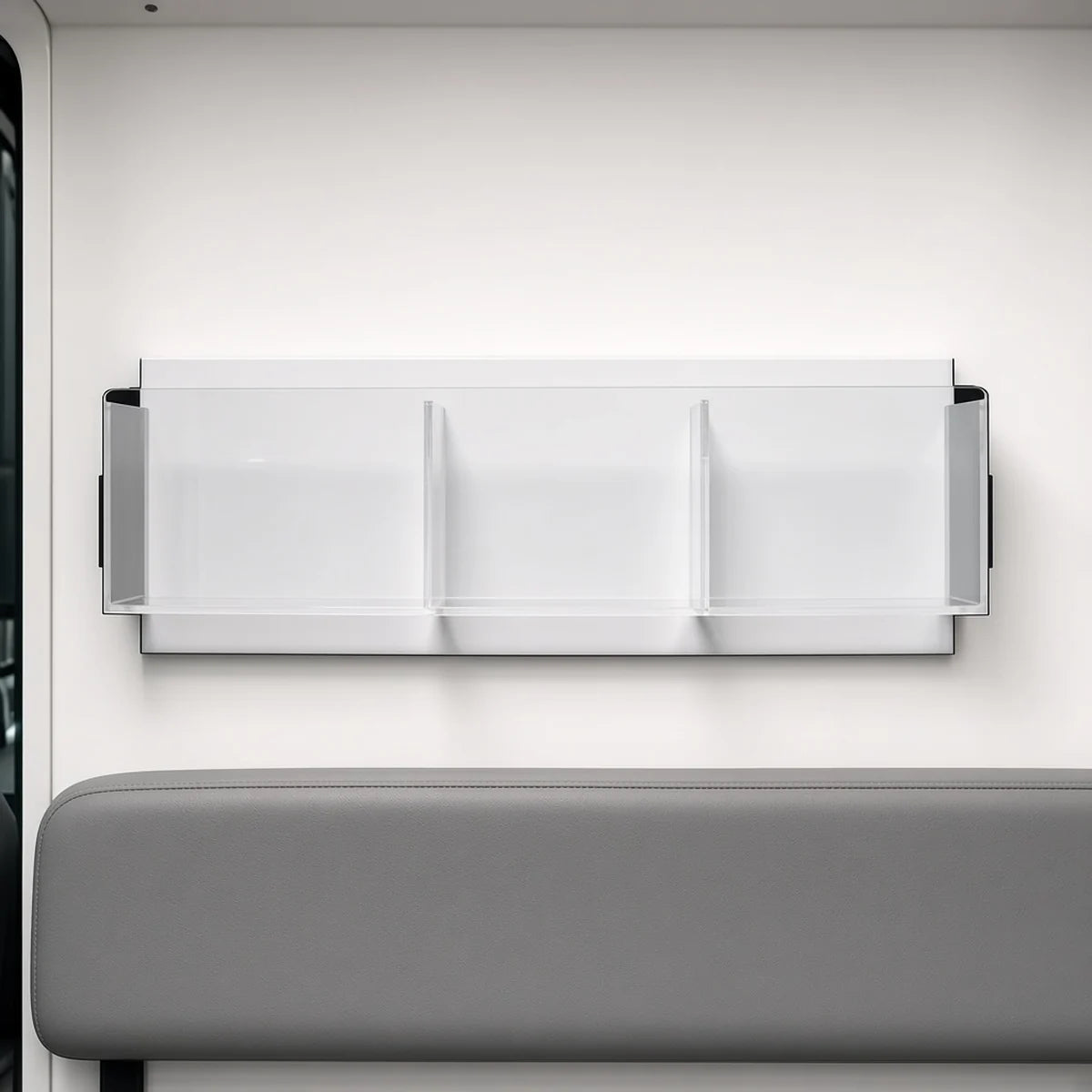 Pacific Biomedical compact acrylic ambulance organizer, 16.75 inches, three clear compartments mounted on an ambulance wall above a bench seat - Pacific Biomedical