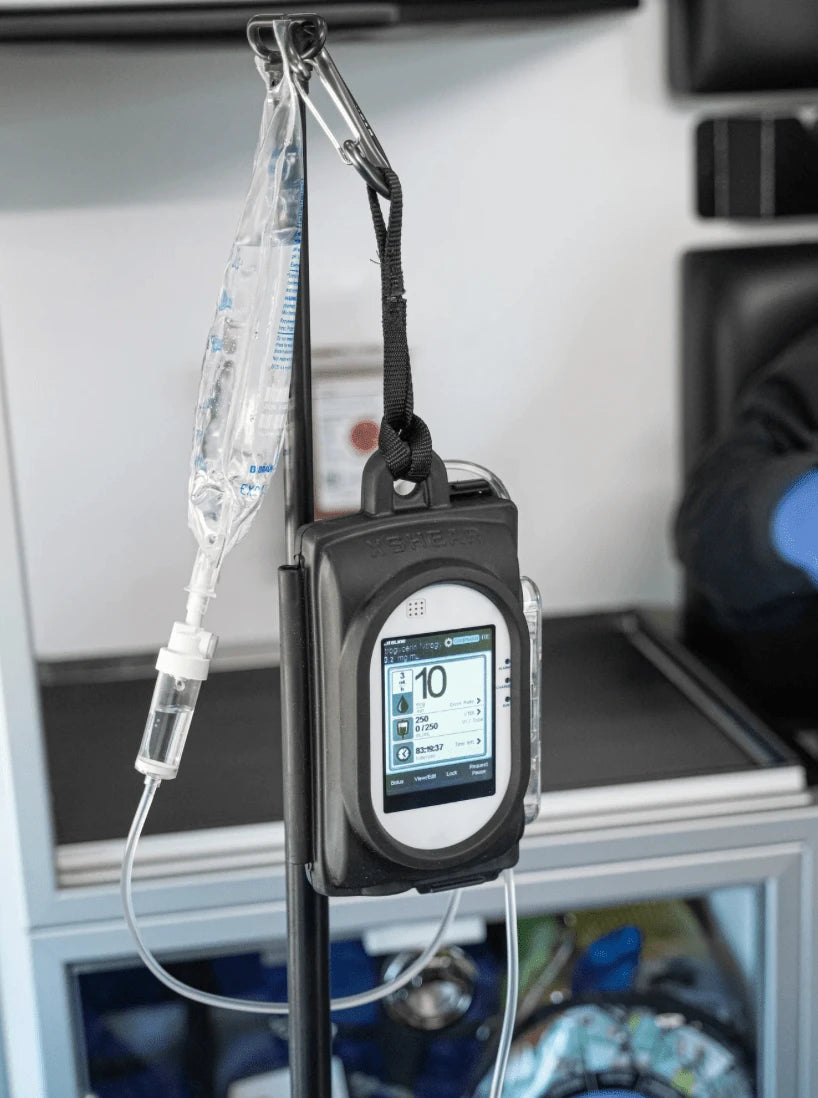 XShear protective thermal plastic elastomer case installed on Sapphire IV Pump, mounted on IV pole in EMS ambulance for maximum impact protection.