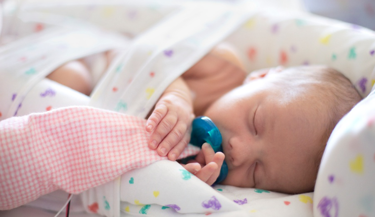 Baby positioned for comfort in the hospital.