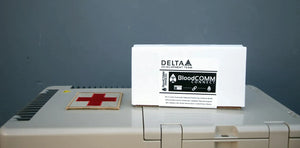 Delta Development Blood Comm Connect in original box sitting on top of a Delta Development APRU 6L Blood Refrigerator. Part Number: A-002013