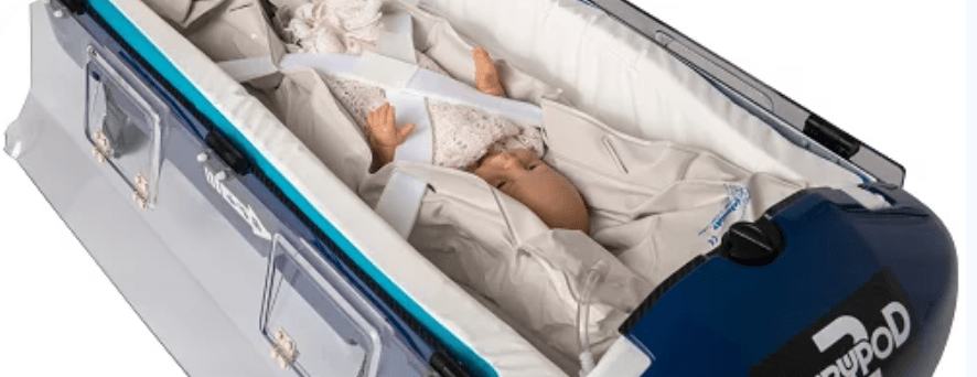 picture of infant secured in baby pod for transport