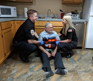 Standard size vinyl binder lift being used by a team of EMTs to lift a patient off the floor. PN: SV-BL