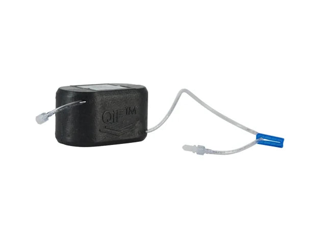 Single QinFlow Compact Disposable Unit showing EPP foam casing and luer lock connections for emergency medical use