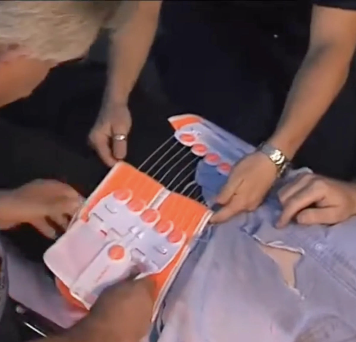 two paramedics applying a TPOD to a patient with a unstable pelvis