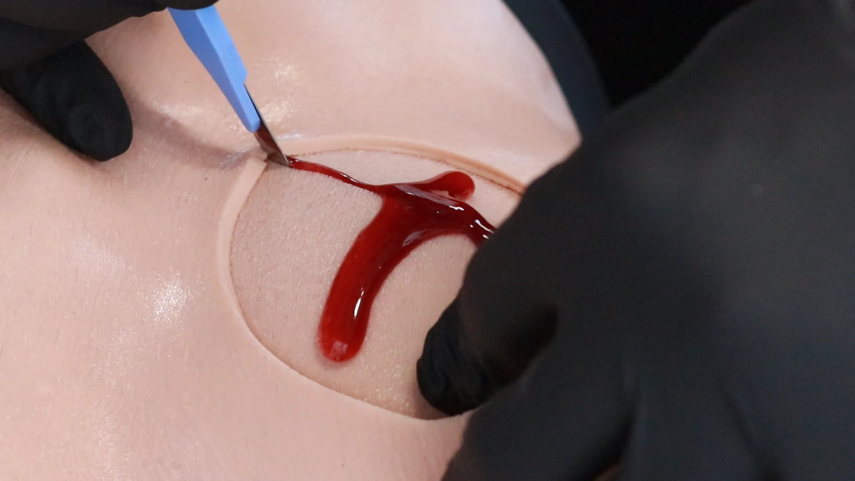 Scalpel cricothyroidotomy practice on the Decent V2 cric module blood-filled insert