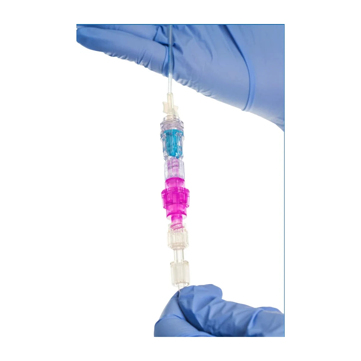 Linear Health Sciences Orchid Safety Release Valve, 1812-B300, held on IV tubing between gloved hands, with a standard luer connector at each end - Pacific Biomedical.